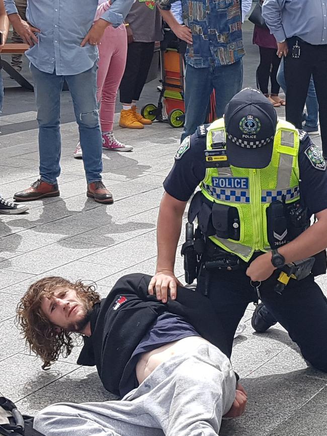 Barry Siecker is arrested after a busker was bashed with a ukulele in Rundle Mall. Picture: Shaun Hollis