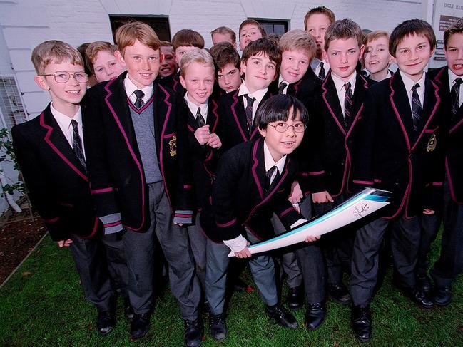 Sport Hutchins School students and Olympic Torch Ken Pang holding the Torch