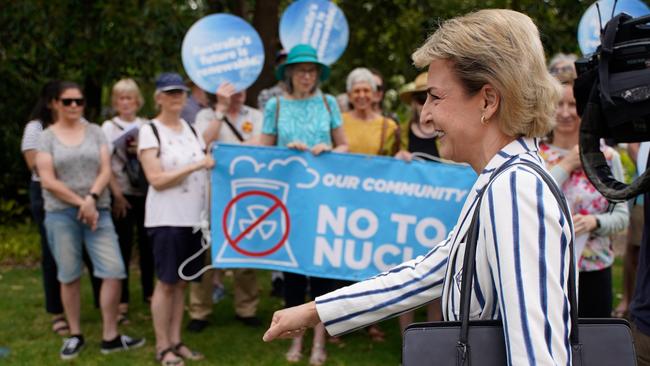 Anti-nuclear protesters chant outside the rally, as opposition senate leader Michaelia Cash walks by. Picture: NewsWire / Valeriu Campan