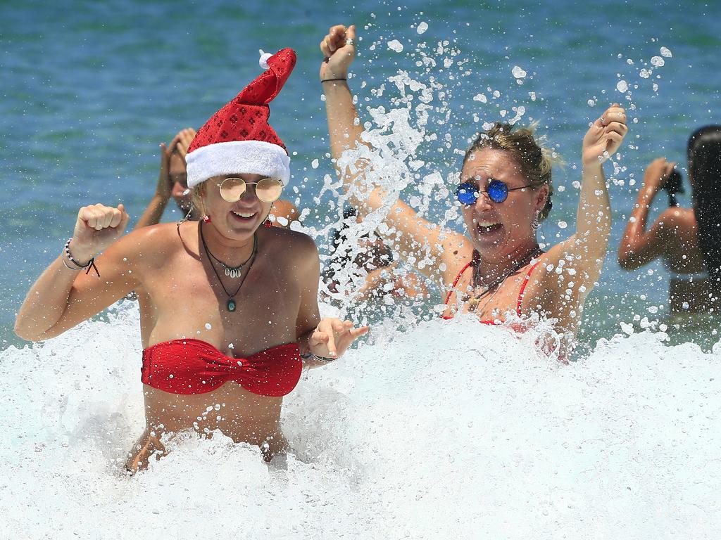 Girls in the surf at Bondi Beach on Christmas Day. Picture: Mark Evans/Getty Images