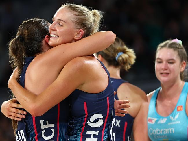 MELBOURNE, AUSTRALIA - APRIL 14: Rudi Ellis of the Vixens (C) embraces teammate Kate Eddy after victory in the round one Super Netball match between Melbourne Mavericks and Melbourne Vixens at John Cain Arena on April 14, 2024 in Melbourne, Australia. (Photo by Graham Denholm/Getty Images)