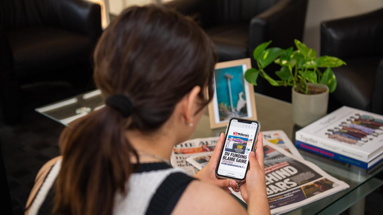 A reader enjoys checking out the NT News digital print edition. Picture: Pema Tamang Pakhrin