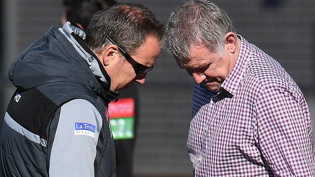 Collingwood head of football Geoff Walsh speaks with a Collingwood official at training on Monday. Picture: AAP