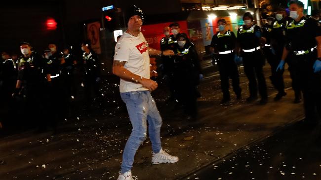 An anti-lockdown protester surrounded by capsicum spray in Melbourne on Thursday night. Picture: AFP