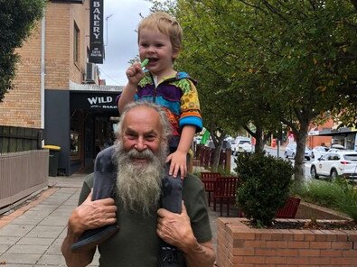 Bushfire survivor and footy fan Robert Fitzclarence with grandson Finn (3) in Gippsland near Mallacoota.