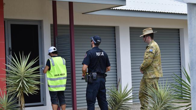 A Public Health environmental health officer, NT Police officer and an Australian Defence Force member check in on those self isolating to ensure they are following quarantine regulations. PICTURE: Will Zwar