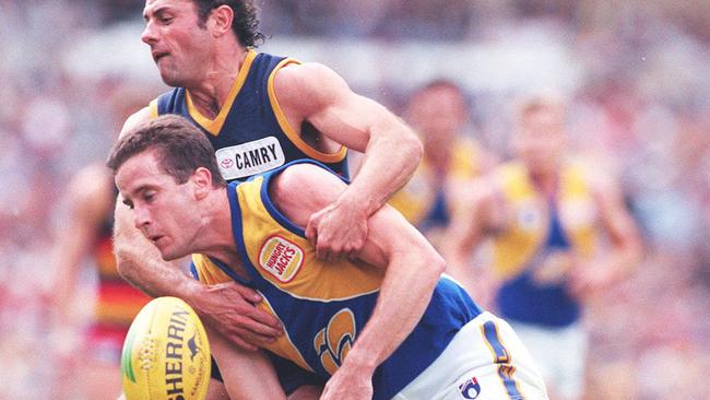 Crows captain Tony McGuinness tackles Don Pyke — now Crows coach — in 1996. The skipper was gone before the start of the 1997 season.