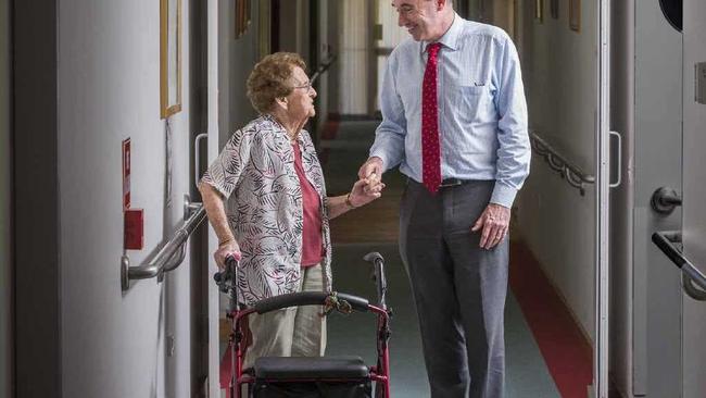 FOLLOW ME: Elsie McFarlane leads Member for Page Kevin Hogan around the Dougherty Villa aged care facility after he announced 56 more places, including 20 at Dougherty Villa. PHOTO: ADAM HOURIGAN