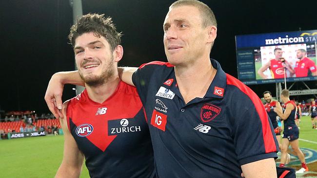 Simon Goodwin embraces Angus Brayshaw after Melbourne’s last-gasp win over Gold Coast. Picture: Jono Searle/AFL Photos/Getty Images.