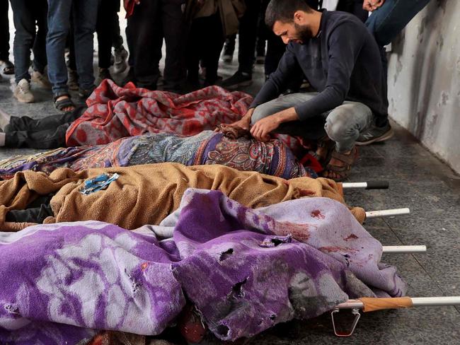 The bodies of people killed during an Israeli strike on Jabalia, in the northern Gaza Strip, lie at Al-Ahli Arab hospital, also known as the Baptist hospital, in Gaza City on December 19, 2024, as the war between Israel and Hamas militants continues. (Photo by Omar AL-QATTAA / AFP)