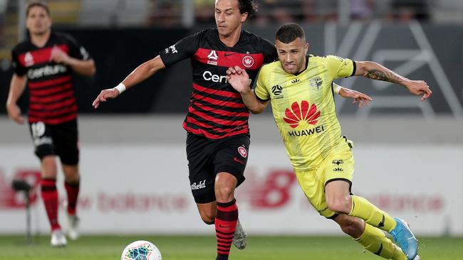 Daniel Georgievski of the Wanderers (left) and Jaushua Sotirio of the Phoenix challenge for the ball. Picture: AAP