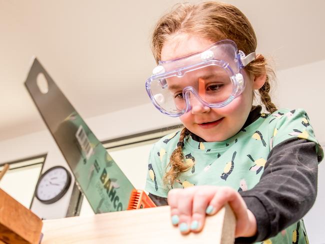 Children at G8 Education’s new Greenwood child care centre in Notting Hill create woodwork with saws, hammers and nails to introduce them to risky play at a time when families are very risk averse. Evie, 5 pictured Picture: Tim Carrafa