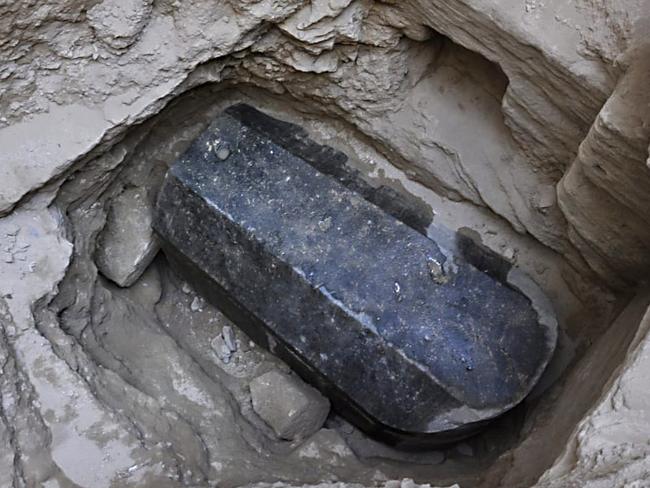 This picture released on July 1, 2018, by the Egyptian Ministry of Antiquities shows an ancient tomb dating back to the Ptolemaic period found in the Sidi Gaber district of Alexandria. The tomb, which dimensions are a height of 185 cm, length 265 cm and width of 165 cm, contains a black granite sarcophagus considered to be the largest to be discovered in Alexandria. The tomb was found at a depth of 5 meters beneath the surface of the land, there is a layer of mortar between the lid and the body of the sarcophagus indicating that it had not been opened since it was closed in antiquity. An alabaster head of a man was also found and most probably belongs to the owner of the tomb. / AFP PHOTO / EGYPTIAN ANTIQUITIES MINISTRY AND AFP PHOTO / - / XGTY / === RESTRICTED TO EDITORIAL USE - MANDATORY CREDIT "AFP PHOTO / HO / EGYPTIAN MINISTRY OF ANTIQUITIES- NO MARKETING NO ADVERTISING CAMPAIGNS - DISTRIBUTED AS A SERVICE TO CLIENTS ==