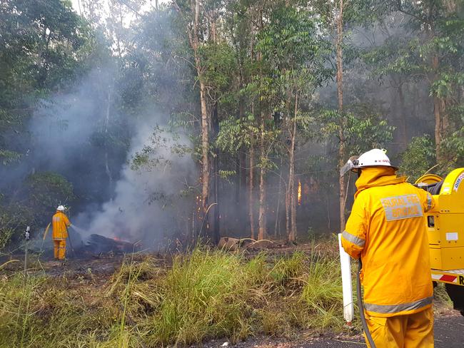 Firefighters tackle the latest blaze at Peregian on the Sunshine Coast.