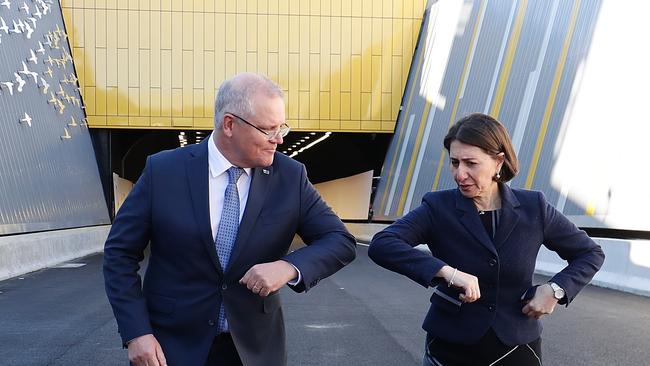 Prime Minister Scott Morrison and NSW Premier Gladys Berejiklian bump elbows (Photo by Mark Metcalfe/Getty Images)