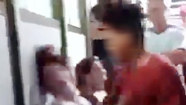 A screen grab from the sickening video of a teenage student being punched in the face at Darwin High School