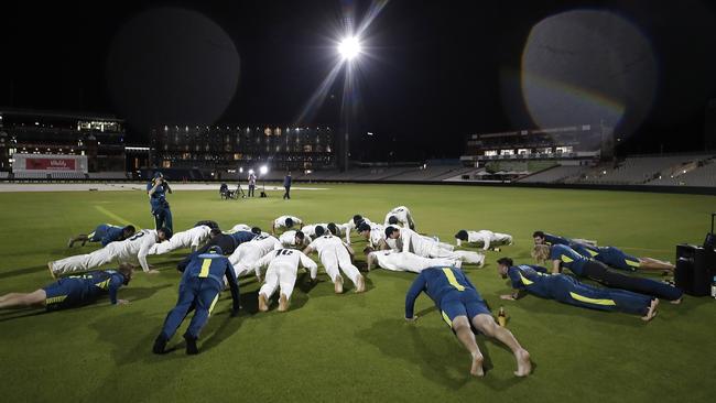 The Australian Team do push ups as they celebrate on the pitch. Picture: Getty Images