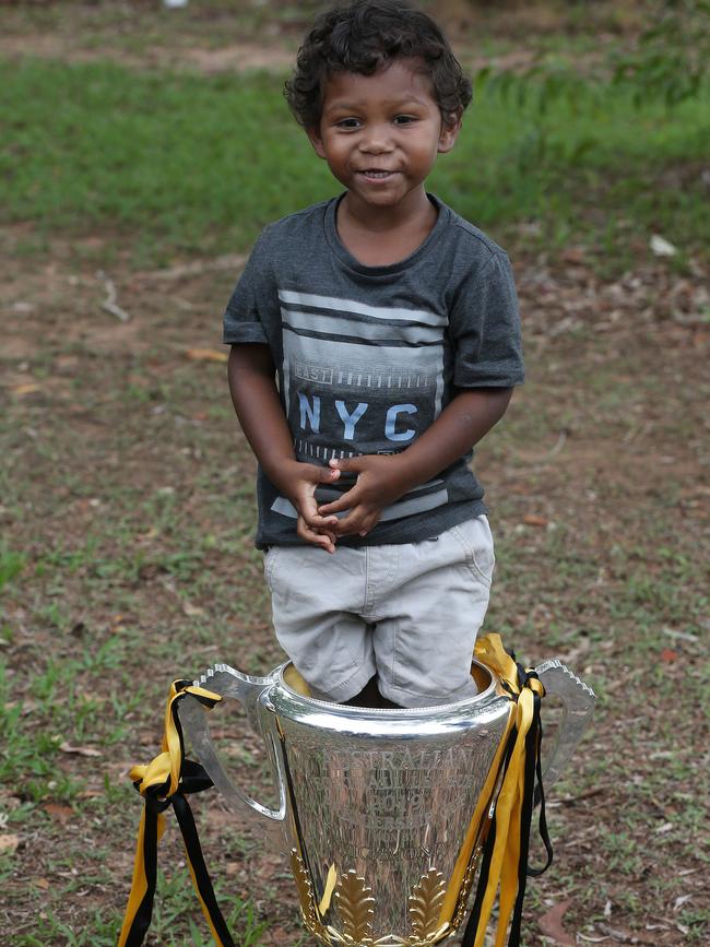 Rioli's nephew Kellan Rioli stands in the cup. Picture: Michael Klein