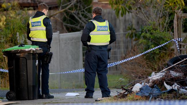 Police keep guard over the crime scene. Picture: Andrew Henshaw