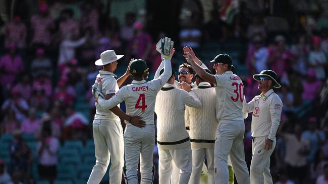 Australia celebrates as the wickets tumble late on day three. Picture: AFP