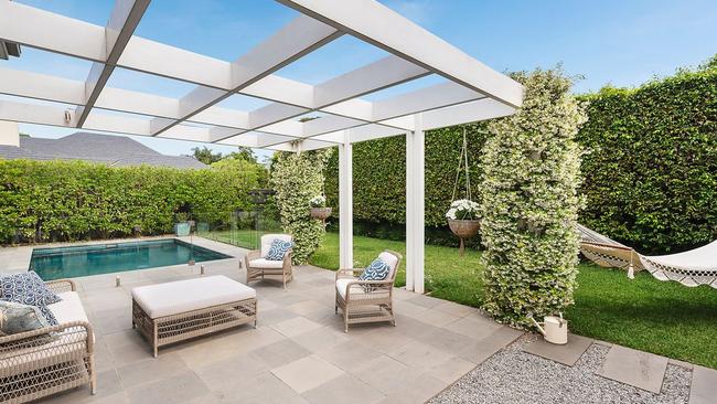 The backyard is a poolside oasis perfect for a summer dinner party.