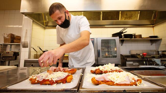 Executive Chef Christian Abbott prepares chicken parmigianas at The Local pub in Port Melbourne ahead of its midnight opening. Picture: Mark Stewart