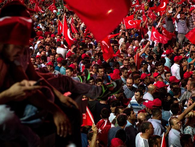 People wave Turkish flags at a rally on the streets of Kizilay Square in reaction to the failed military coup on July 17, 2016 in Ankara, Turkey. Picture: Getty.