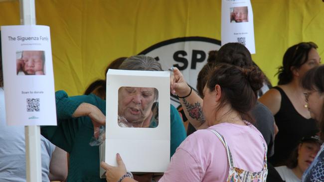 Dozens descended on the Alice Springs baseball field on Friday, December 13 to attend a bake sale to raise funds for the Siguenza family. Picture: Gera Kazakov