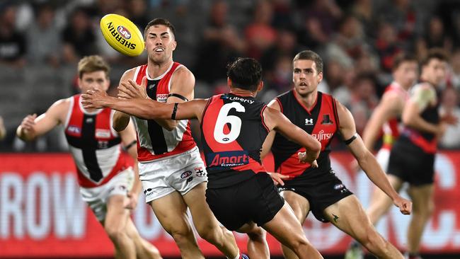 St Kilda’s Jade Gresham fires out a handball under pressure from Bomber Jye Caldwell. Picture: Quinn Rooney/Getty Images