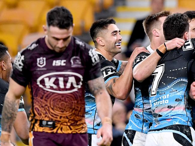 BRISBANE, AUSTRALIA - JULY 31: Braden Hamlin-Uele of the Sharks is congratulated by team mates after scoring a try during the round 12 NRL match between the Brisbane Broncos and the Cronulla Sharks on July 31, 2020 in Brisbane, Australia. (Photo by Bradley Kanaris/Getty Images)