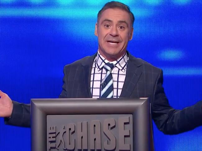 Screen grab of Andrew O'keefe  on The Chase Episode 59 - Wed 8 Jul of 7plus, wedding band on, https://7plus.com.au/the-chase-australia