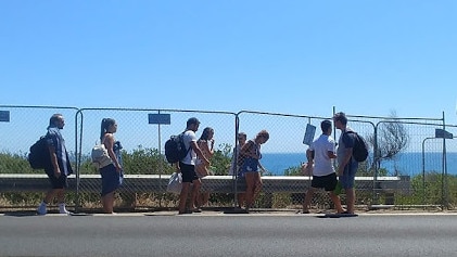 Another group of people accessing The Pillars despite the fence and warning signs.