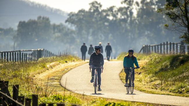 Charlotte Blake of Stirling and Josh Partington of Goodwood enjoy a ride along the Amy Gillett bikeway. Picture: Darren Clements.