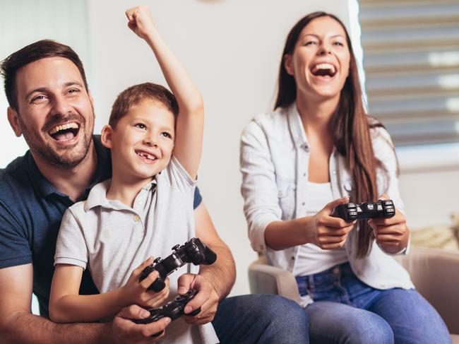 Parents sharing video gaming with their children is not only fun but can help keep them safe online. For Kids News and Hibernation. iStock image