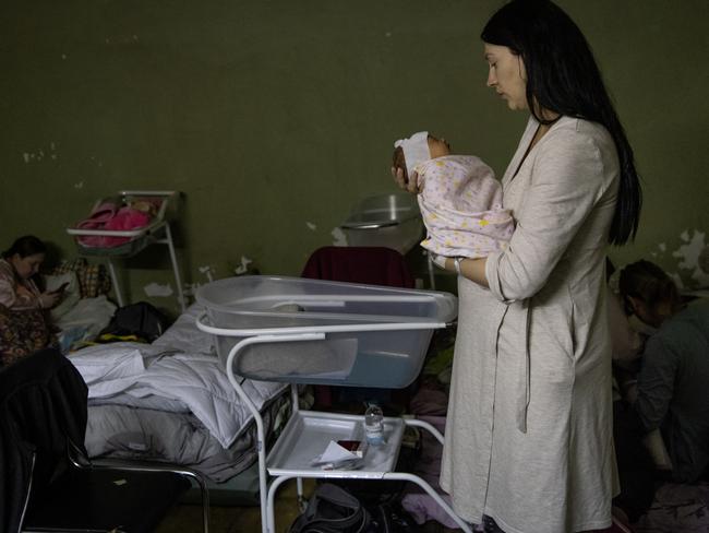 A mother holds her newborn baby in the bomb shelter of a maternity hospital in Kyiv, Ukraine. Picture: Getty Images