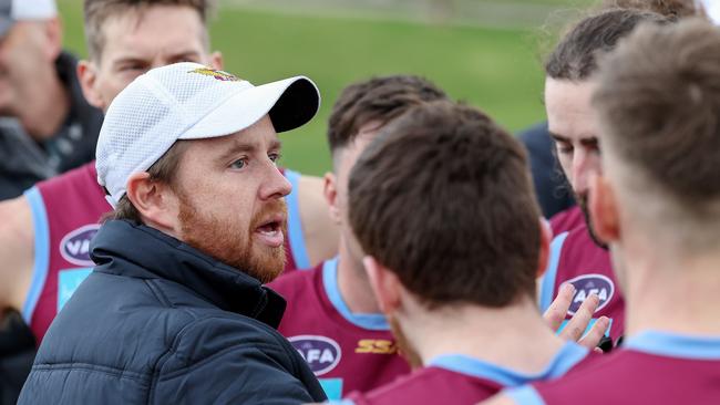 Marcellin coach Simon Abrahams talking to his players during last year’s clash against Monash Blues. Picture: George Salpigtidis