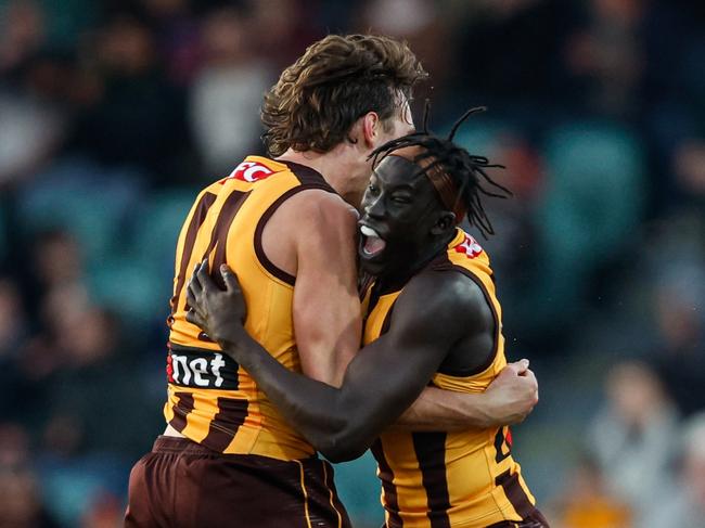 Changkuoth Jiath and Jack Scrimshaw embrace after the siren sounds in Launceston. Picture: Dylan Burns/AFL Photos via Getty Images