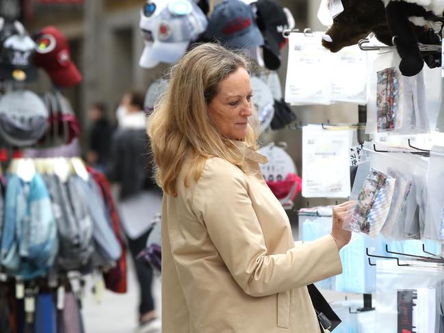 A woman looks at protective face masks for sale in a Munich shop. Picture: Getty Images