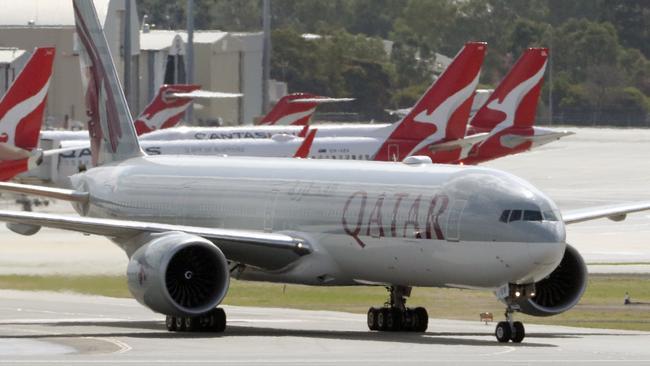 A Qatar Airways aircraft arrives with passengers from Italian cruise liners at Perth International airport in Perth, Monday, March 30, 2020. About 270 Australians are on board the flight, including 120 West Australians. No passengers with coronavirus symptoms were allowed to board.(AAP Image/Richard Wainwright) NO ARCHIVING