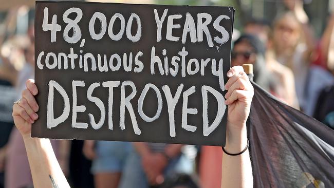 Protesters are seen during a rally outside the Rio Tinto office in Perth, Tuesday, June 9, 2020.. Rio Tinto recently detonated explosives in an area of the Juukan Gorge in the Pilbara, destroying two ancient deep-time rock shelters, much to the distress of the Puutu Kunti Kurrama and Pinikura people. (AAP Image/Richard Wainwright) NO ARCHIVING