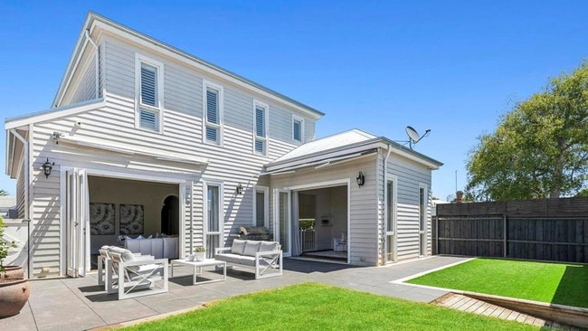 Remote-controlled awnings create a flexible outdoor entertaining area at the back of the home.