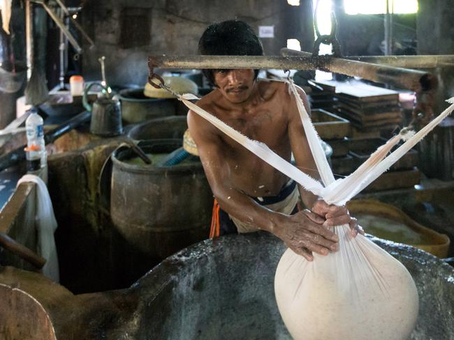 21 May 2019, Klagen Tropodo, East Java, Indonesia: A local man works at a factory producing tofu at Klagen Tropodo village outside Surabaya, Indonesia. Millions of tonnes of recyclable plastic trash from Australia and Europe is dumped for rag pickers to separate and sort. The plastics are used to fuel fires at local tofu factories among other industries. Australia is illegally sending non recyclable trash hidden within this lode and the Indonesian Government is cracking down on the practice and preparing to refuse to take Australia's rubbish that is creating environmental and health issues locally. Picture by Graham Crouch/The Australian