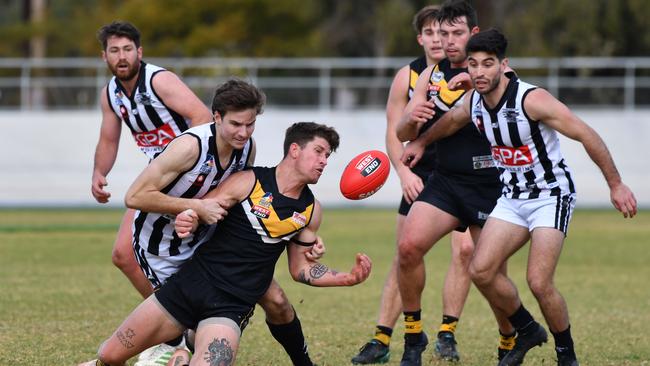 Payneham’s James Neale tackles Brighton’s William Rivers on Saturday. Picture: Keryn Stevens