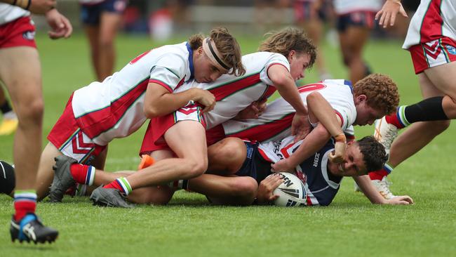 Central Coast Roosters’ player Owen Knowles tackled by the Monaro Colts defence in round one of the Andrew Johns Cup. Picture: Sue Graham