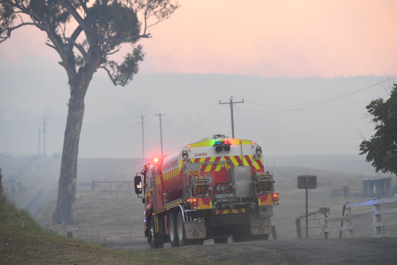 Trucks moving in and out of the road leading to the fire at Tabulam.