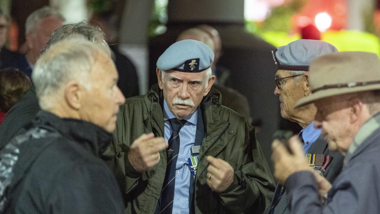 Past Legacy president Dave Melandri catches up with Royal Australian Electrical and Mechanical Engineers (RAEME) mates at the bus interchange before the march to the Anzac Day Toowoomba Dawn Service, Tuesday, April 25, 2023. Picture: Kevin Farmer