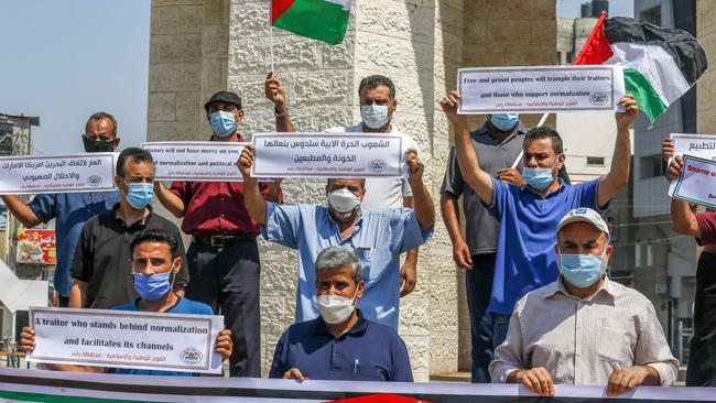 Palestinians carry placards during a protest in Rafah in the southern Gaza Strip to condemn the normalisation of ties between Israeli and Bahrain. Picture: AFP