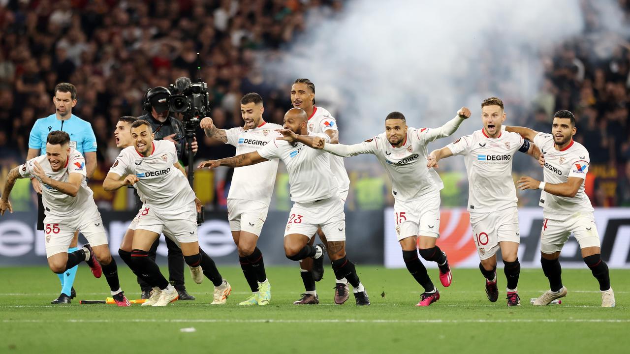 BUDAPEST, HUNGARY - MAY 31: Players of Sevilla FC celebrate after Gonzalo Montiel of Sevilla FC (not pictured) scores the team's fourth penalty in the penalty shoot out during the UEFA Europa League 2022/23 final match between Sevilla FC and AS Roma at Puskas Arena on May 31, 2023 in Budapest, Hungary. (Photo by Maja Hitij/Getty Images)