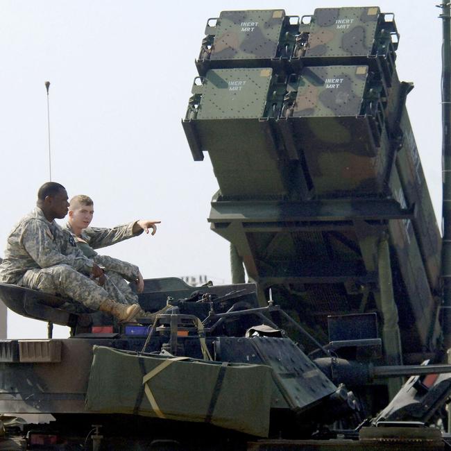 US soldiers from 2006 sit on a turret of the M2A2 Bradley Fighting Vehicle in front of the launcher of a Patriot missile PAC-3 system. Picture: AFP