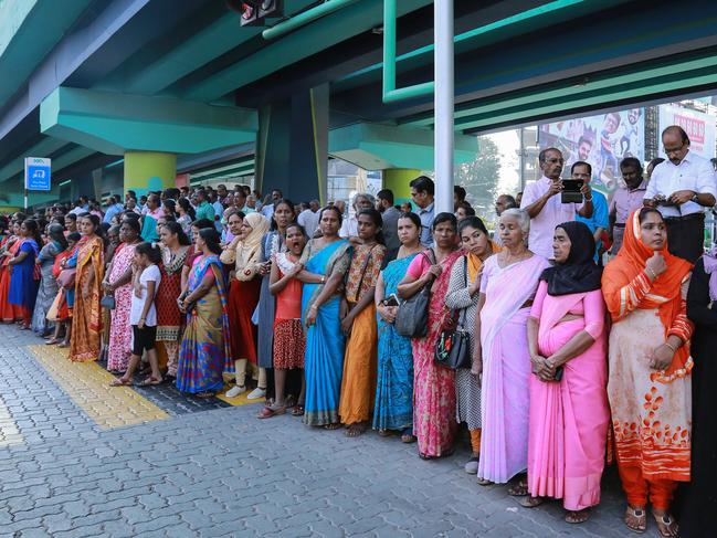 Indian women stand in a line to take part in a "women's wall" protest in Kochi in southern Kerala state on January 1, 2019. - Tens of thousands of women formed a human chain across a southern Indian state on January 1, in support of a court order overturning a partial ban on women entering one of Hinduism's holiest temples, witnesses said. (Photo by - / AFP)